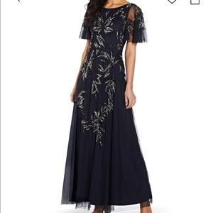 Fluttery sleeves and intricate
embellishment gown by Adrianna Papell